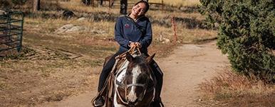 young woman riding horse